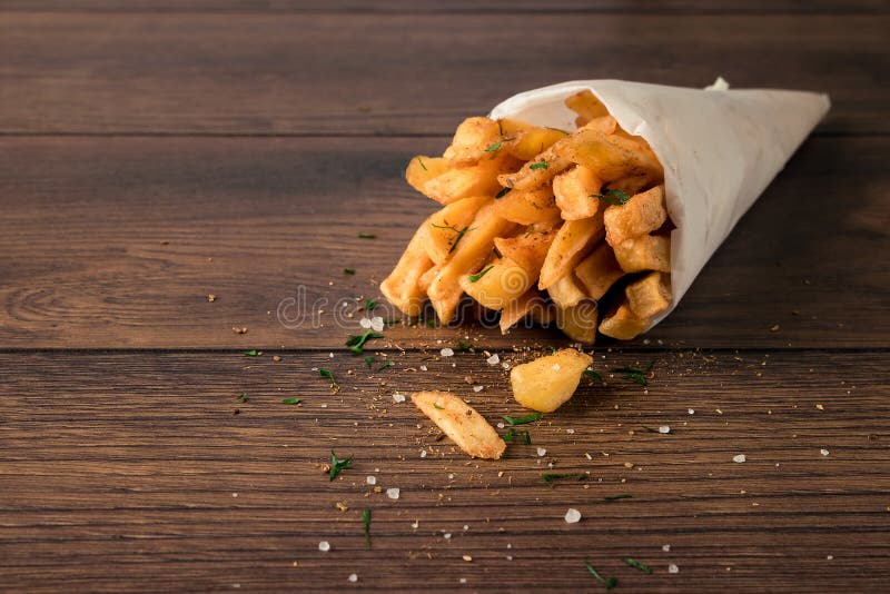 French Fries In A Small Brown Paper Bag. Shallow Depth Of Field