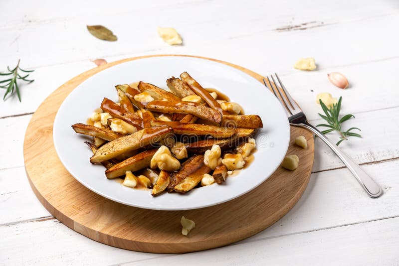 French fries poutine dish on white royalty free stock image French fries poutine dish on white royalty free stock image