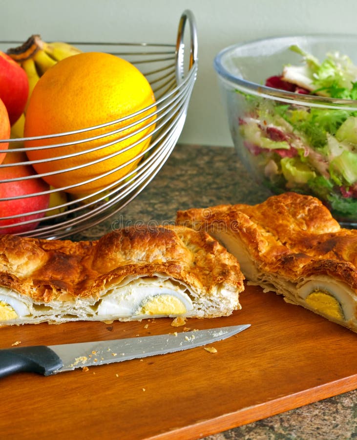Cut open home baked puff pastry egg pie. stock photos