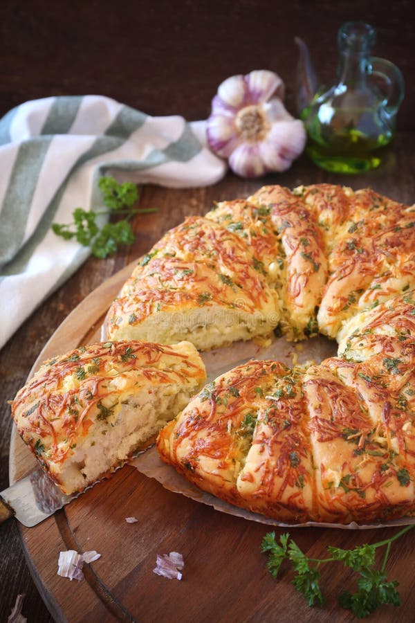 French homemade sourdough white bread with garlic, grated cheese, olive oil and parsley