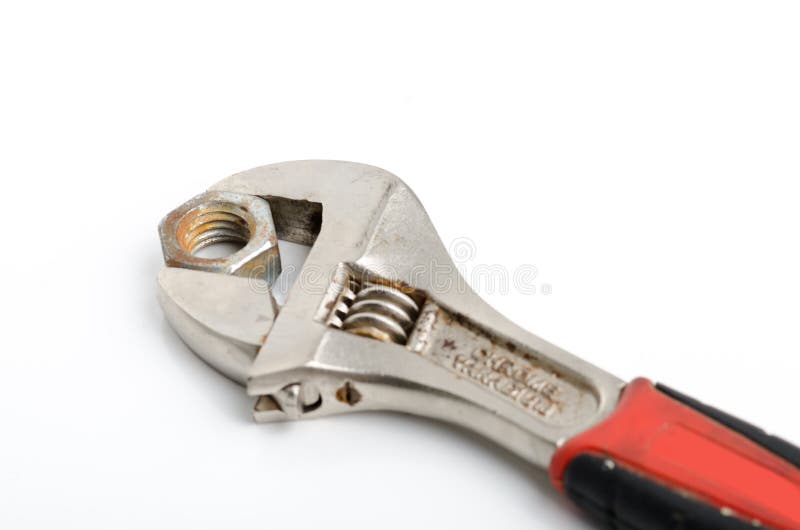 French Key Wrench and Rusted Nut on White Background Stock Image