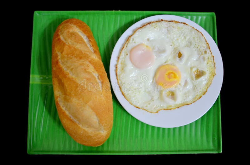 French loaf or baguette served with fried egg royalty free stock images