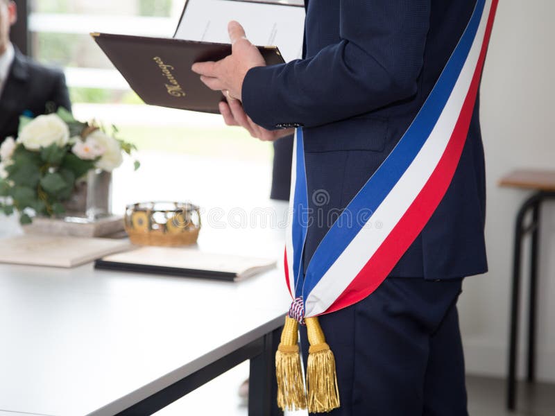 A French mayor with a scarf flag during weeding day