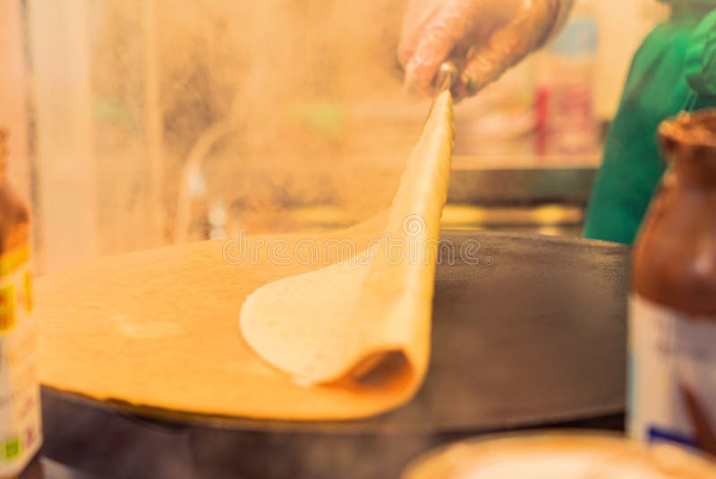 French Pancake Cooking Process. Street Food in Paris. Stock Photo