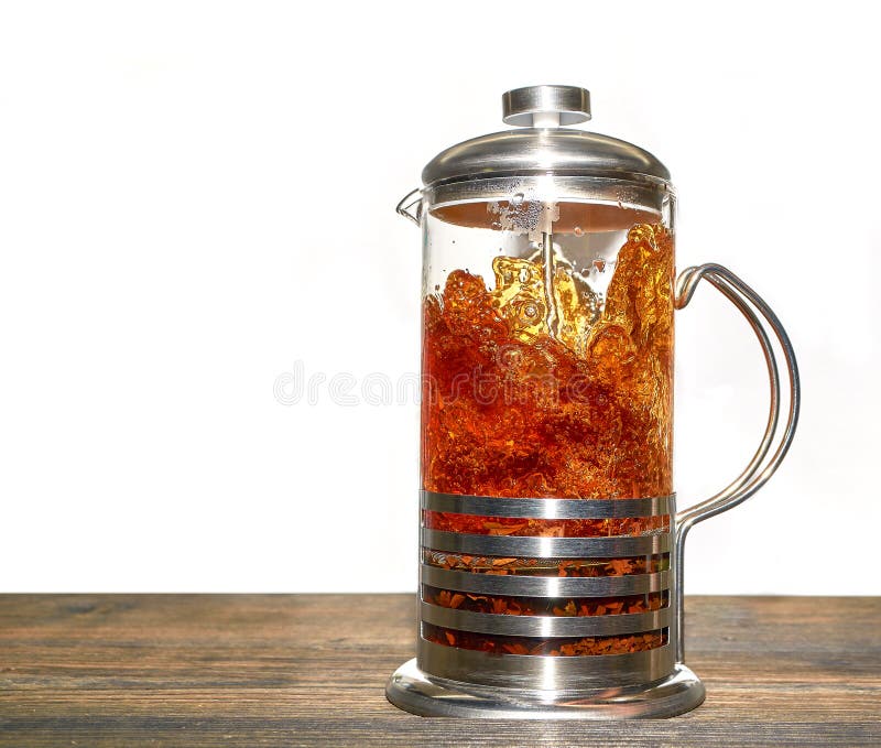 A French Press for Making Coffee and Tea, Filled with Black Tea, is on