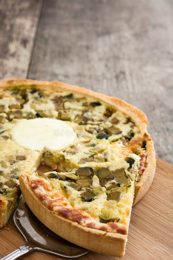 French Quiche with Vegetables on a Rustic Wooden Table Stock Photo