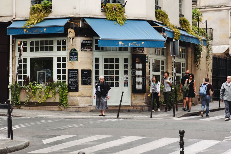 French Restaurant and Walking People in Paris Editorial Photography