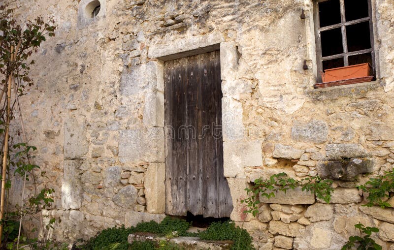 Facade of an old French stone farm in a village