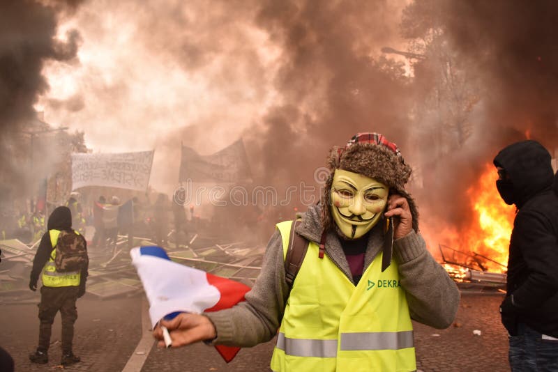 French Yellow Vest Protestor wearing Guy Fawkes mask at a Demonstration in Paris