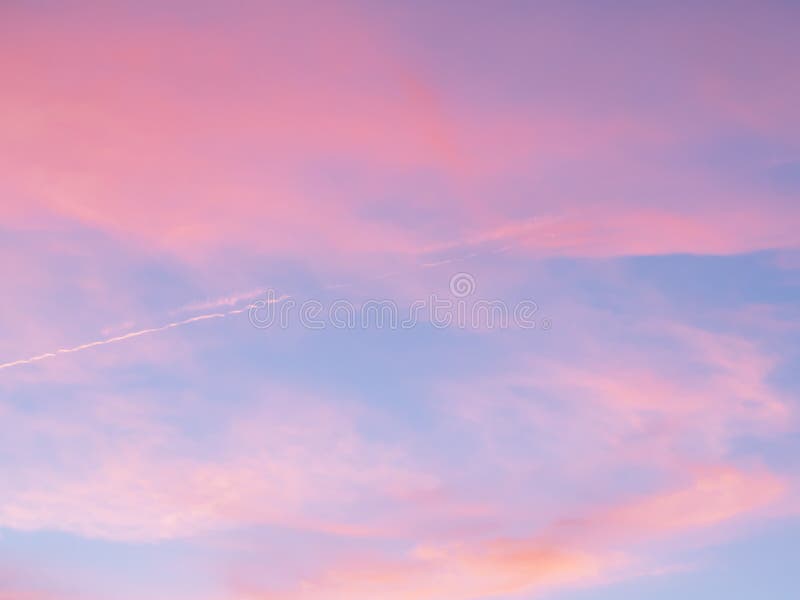 Soft, fluffy and colorful cloud formation. Abstract idyllic pink and blue sky. Blur background texture of colorful sunset clouds. stock image