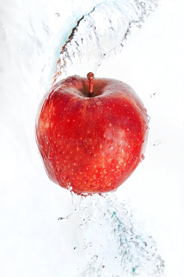 Fresh an apple in streaming water.