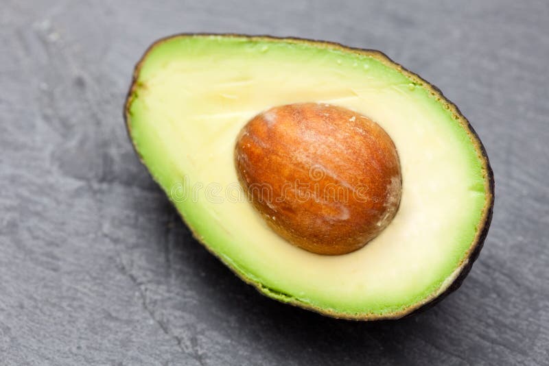 Fresh Avocado, Lime, Drink and Nacho Chips Lying on Marble Background