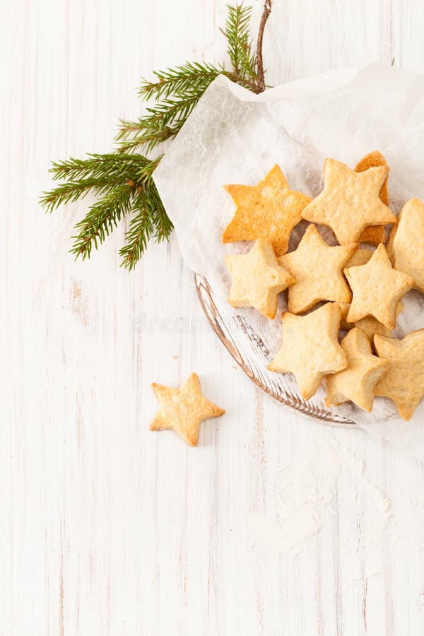 Fresh baked biscuits on the baking paper with fir branch on white stock photography Fresh baked biscuits on the baking paper with fir branch on white stock photography