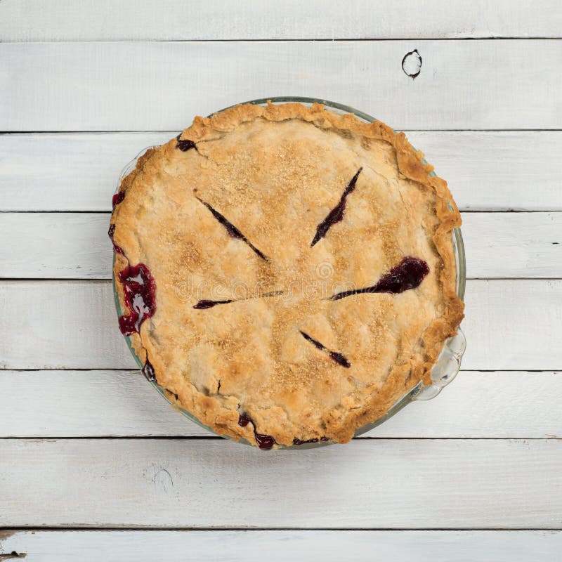 Fresh Baked Blackberry Pie that is Homemade and Messy on White or Gray Shiplap Board Background Table with a Square Crop and an above, looking-down view. Some room on sides for copy, text or words