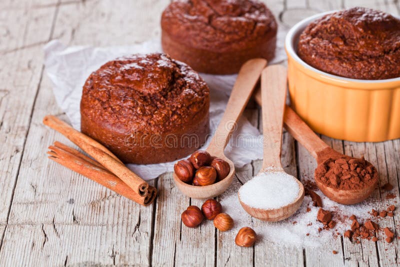 Fresh baked browny cakes, sugar, hazelnuts and cocoa powder