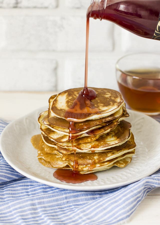 Homemade pancake poured syrup drops in white plate, closeup stock photography Homemade pancake poured syrup drops in white plate, closeup stock photography