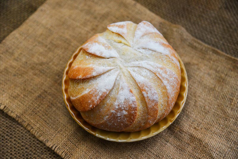 Fresh Bakery bread tray on the sack background homemade breakfast food concept / Round loaf of bread