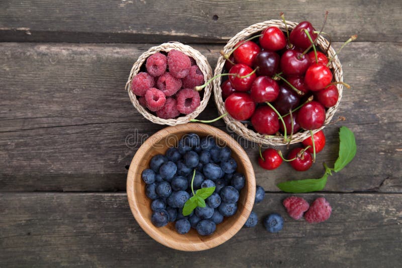 Fresh berries on a wooden table. Raspberry basket stock images, royalty-free photos and pictures