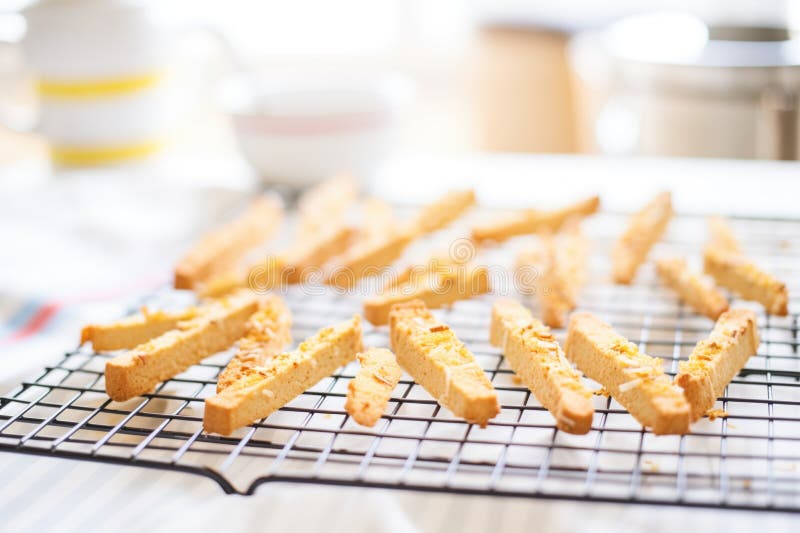 Fresh biscotti batch on cooling wire rack, created with generative ai AI generated