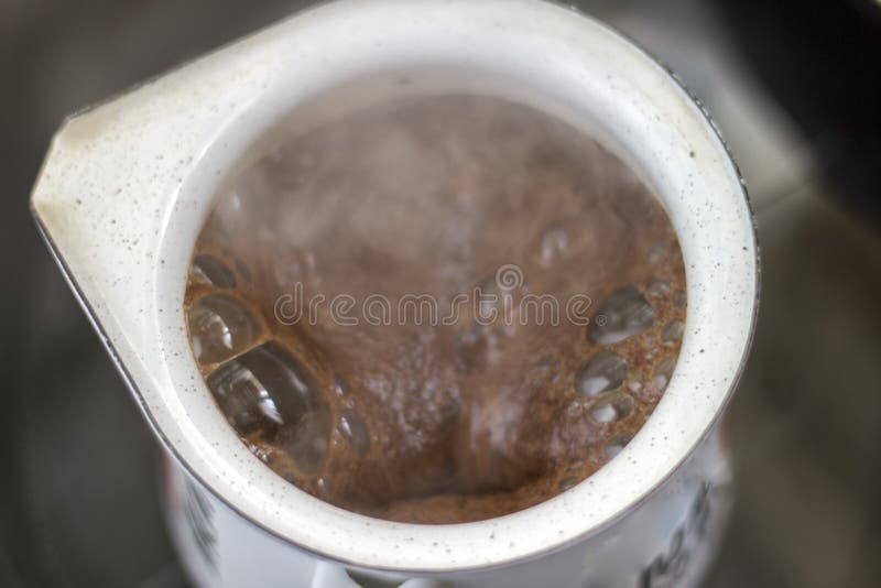 The Coffee is Boiling. Have Crema Flowing Up on the Moka Pot Stock