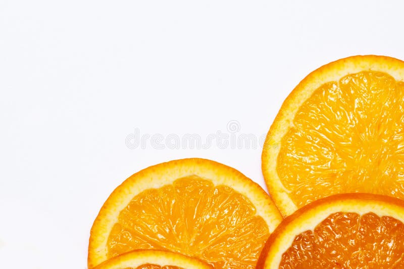 Fresh bright round orange slices on a white isolated background in the right corner of the frame. Flat layout, top view, bright royalty free stock photos