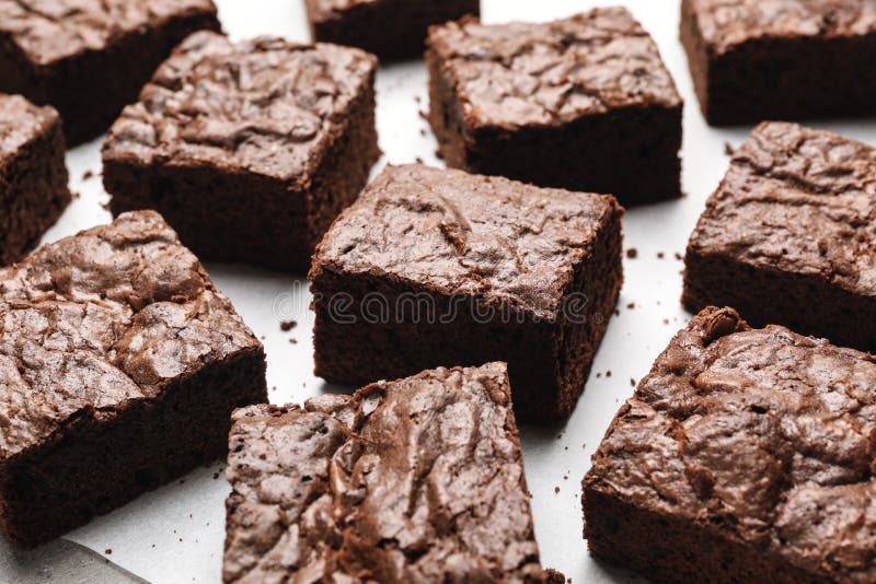 Fresh Brownies on Parchment Paper. Delicious Chocolate Pie Stock Photo