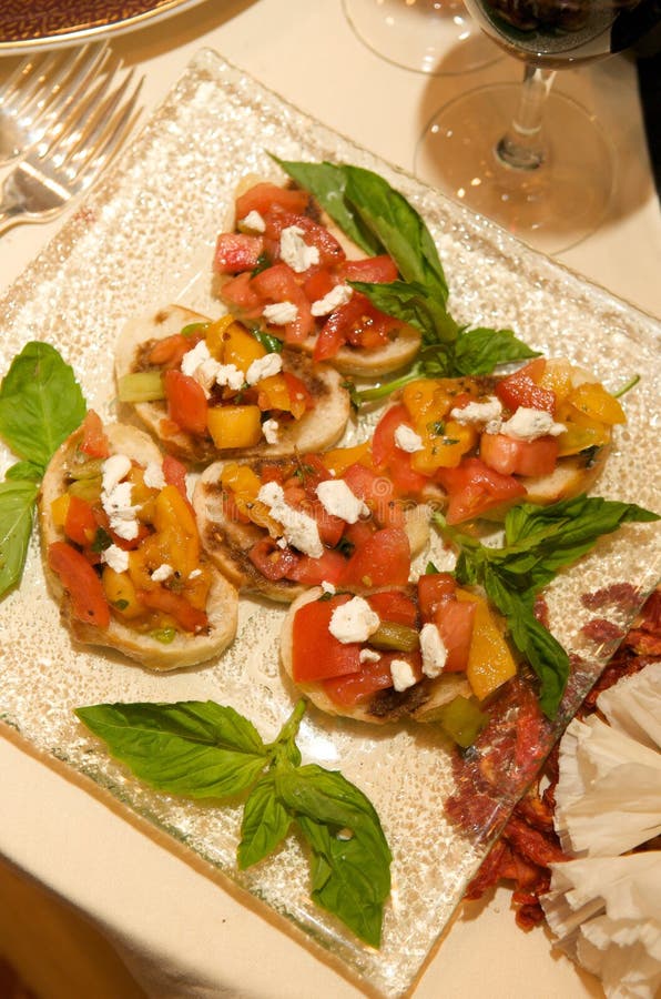 Fresh bruschetta with basil garnishes