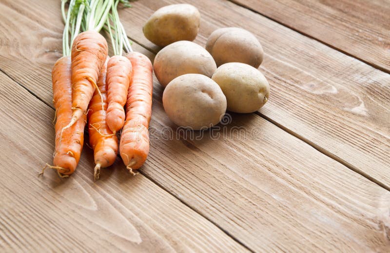 Fresh Carrots And Potatoes On A Wooden Background Stock Image Image