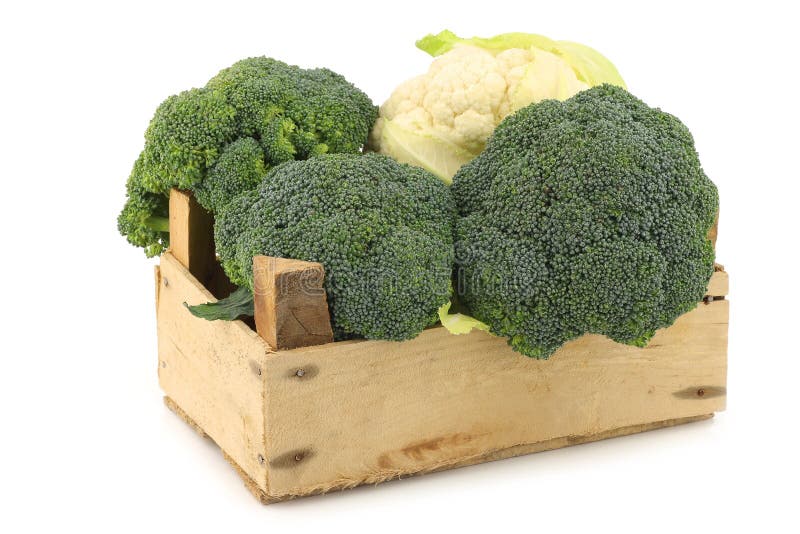 Fresh cauliflower and broccoli in a wooden crate