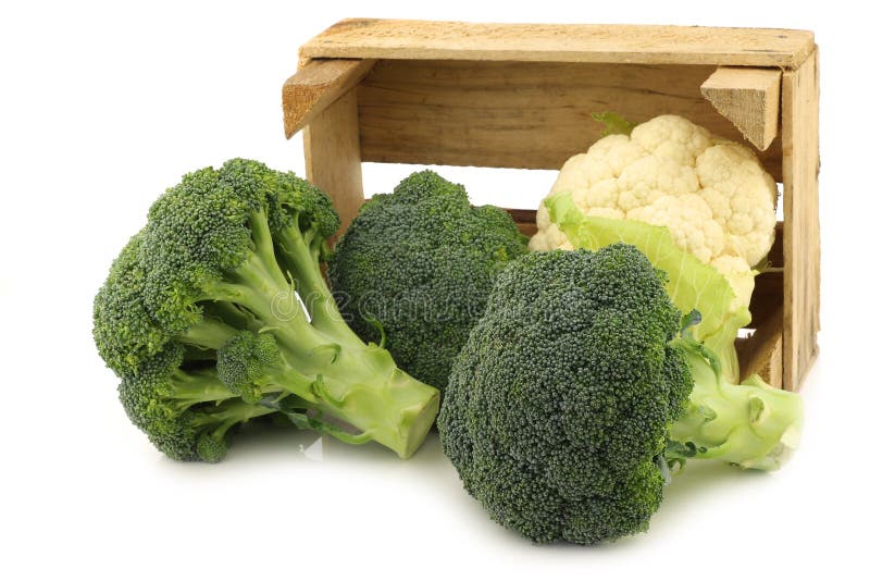 Fresh cauliflower and broccoli in a wooden crate