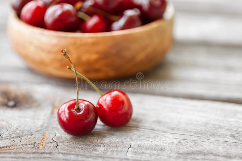 Fresh cherries on wooden background. Red ripe cherry royalty free stock photos Fresh cherries on wooden background. Red ripe cherry royalty free stock photos