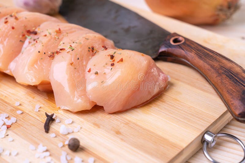 Fresh Chicken Breast Steaks, Knife and Spices on Cutting Board. Top