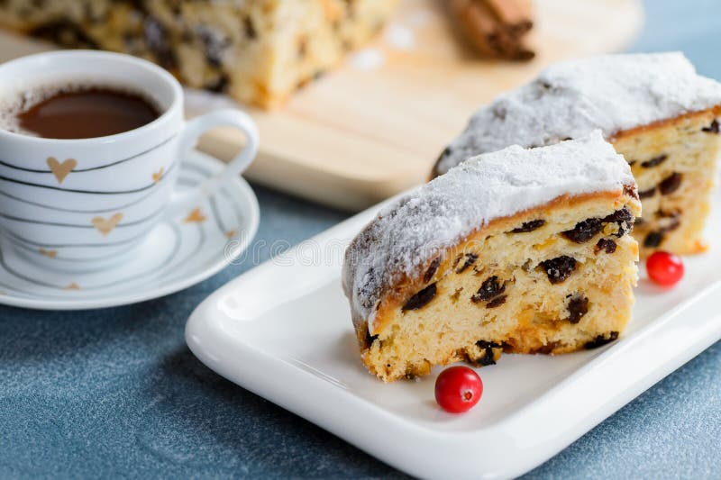 Fresh christmas stollen with raisins and a cup of coffee. royalty free stock photo