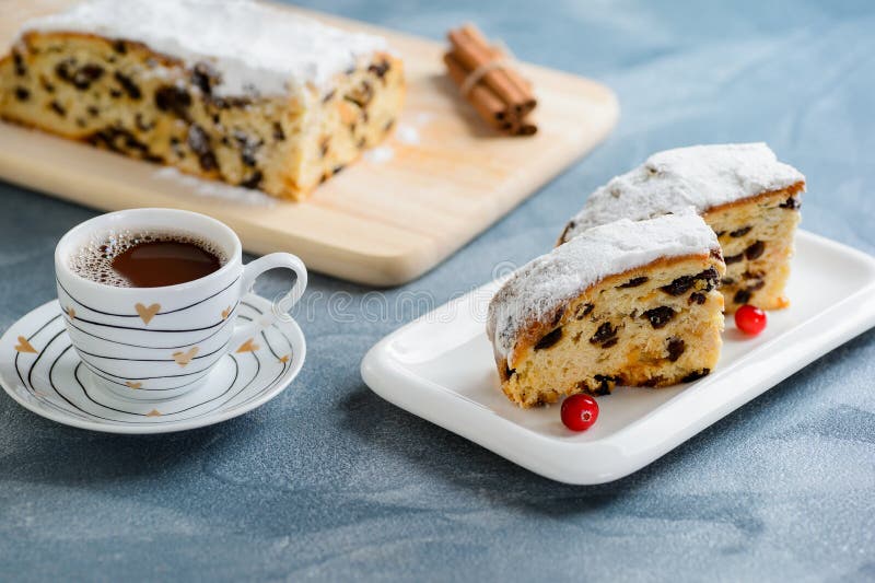 Fresh christmas stollen with raisins and a cup of coffee. stock photography