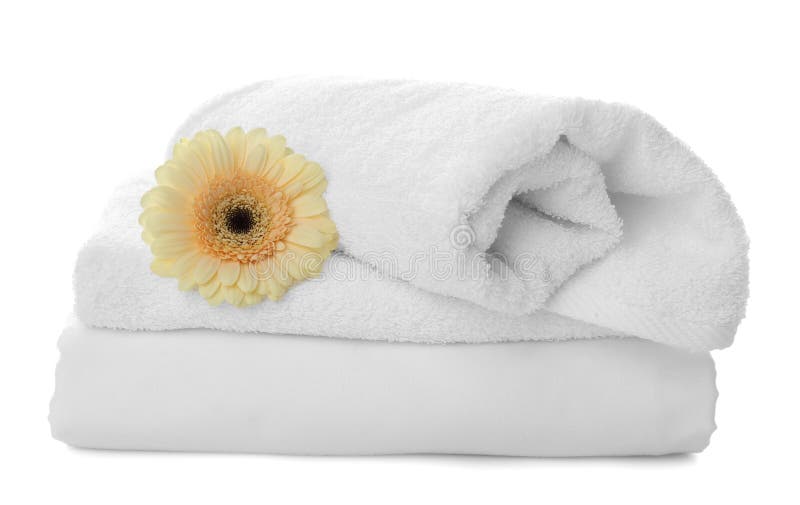 Fresh Clean Towels, Bed Sheet and Gerbera on White Stock Photo Image