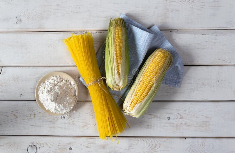 Fresh Cob of Corn and Flour. Gluten Free Pasta Spaghetti on Fabric