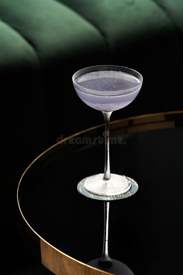 Fresh cocktail glass on glass table in night club restaurant