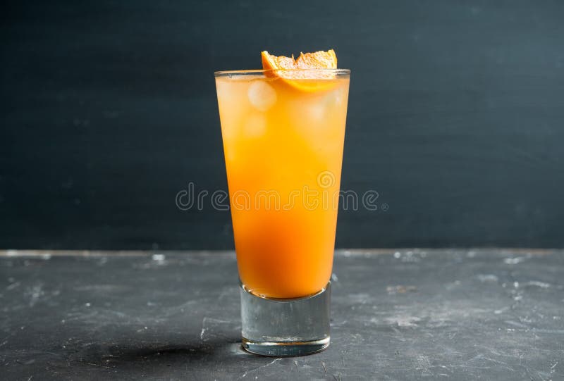 Fresh Cocktail with Vodka and Orange Juice on the Rustic Background