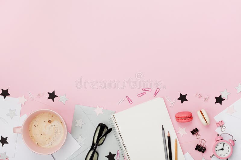 Fresh coffee, macaron, office supply, alarm clock and notebook on pink pastel table top view. Flat lay style. Cozy breakfast. royalty free stock images Fresh coffee, macaron, office supply, alarm clock and notebook on pink pastel table top view. Flat lay style. Cozy breakfast. royalty free stock images