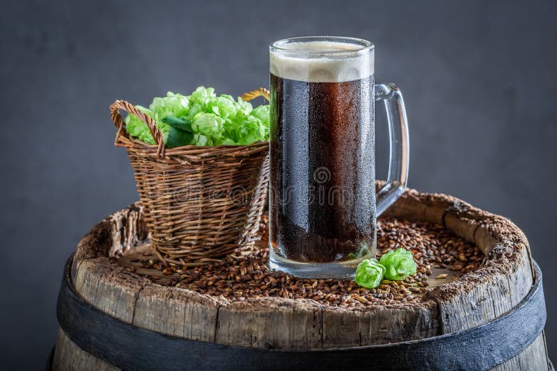 Fresh and Cold Pint of Dark Beer on Wooden Barrel Stock Image Image