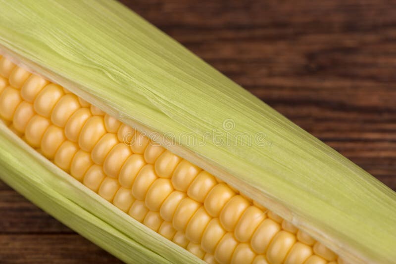 Fresh corn cob on the wooden table closeup, top view stock image Fresh corn cob on the wooden table closeup, top view stock image