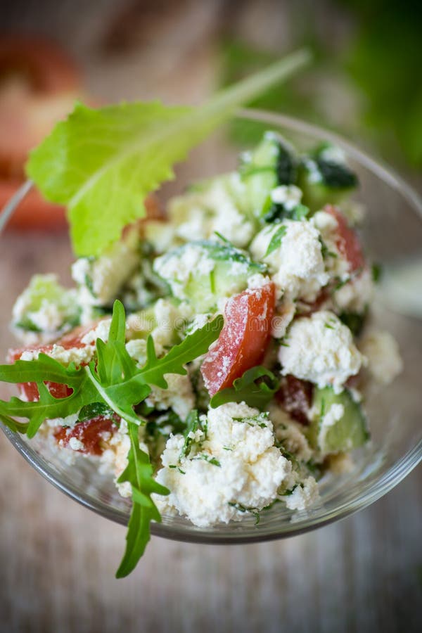 Fresh Cottage Cheese Salad with Cucumbers and Tomatoes with Herbs in a