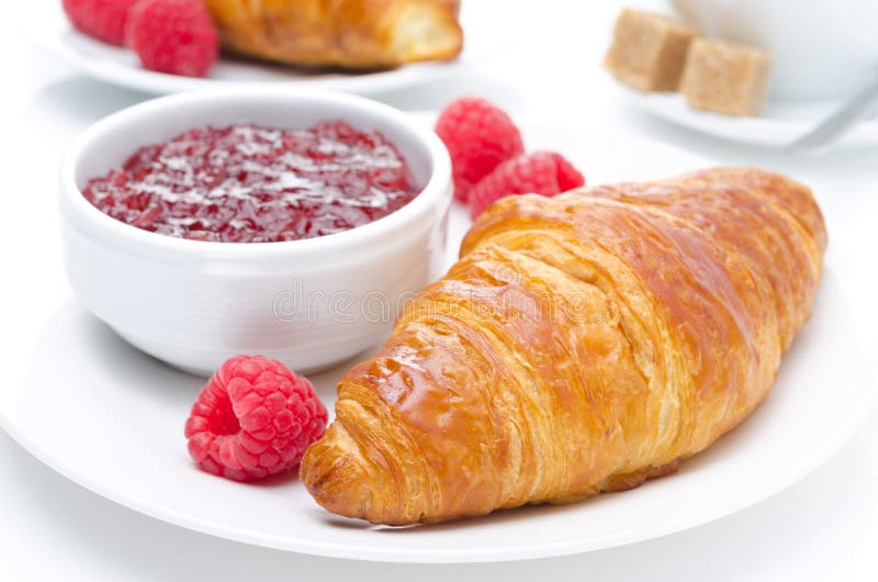 Fresh croissant, raspberry and jam for breakfast close-up