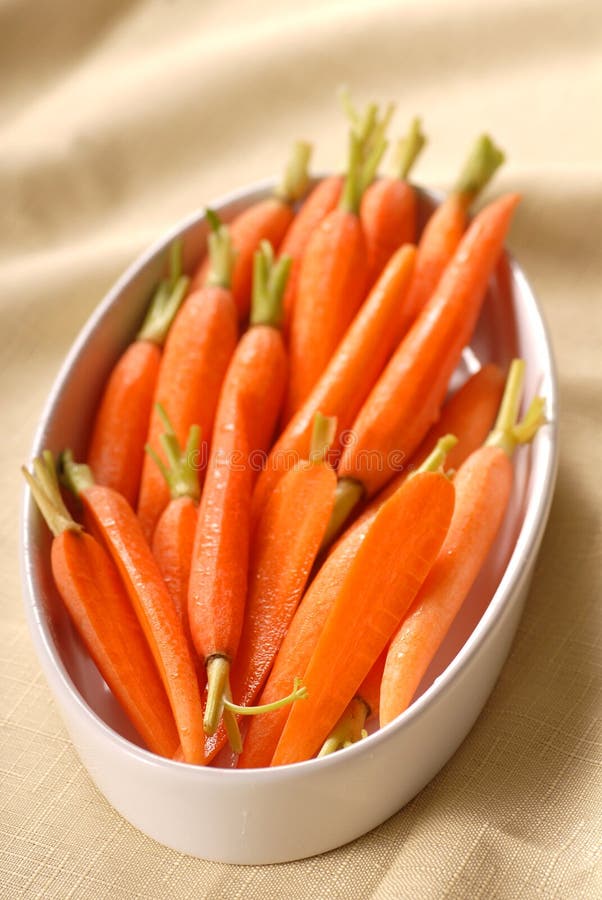 Fresh cut baby carrots in a serving dish