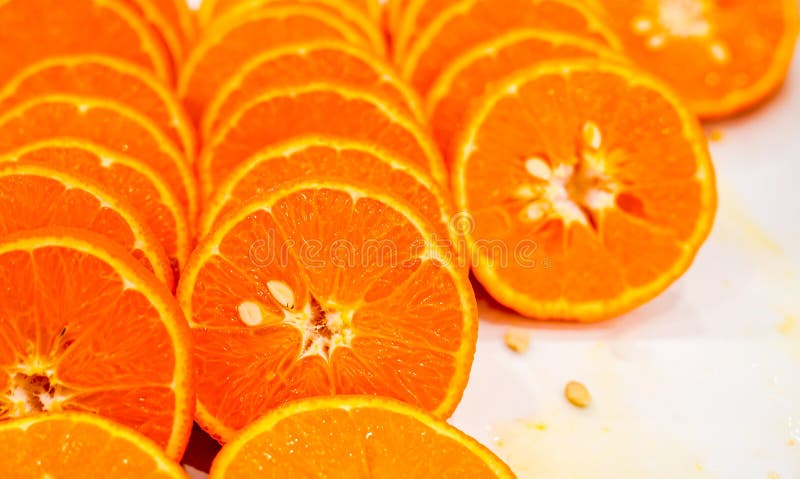 Fresh cut orange fruit background, many pieces of oranges, macro close up photo of healthy food, top view