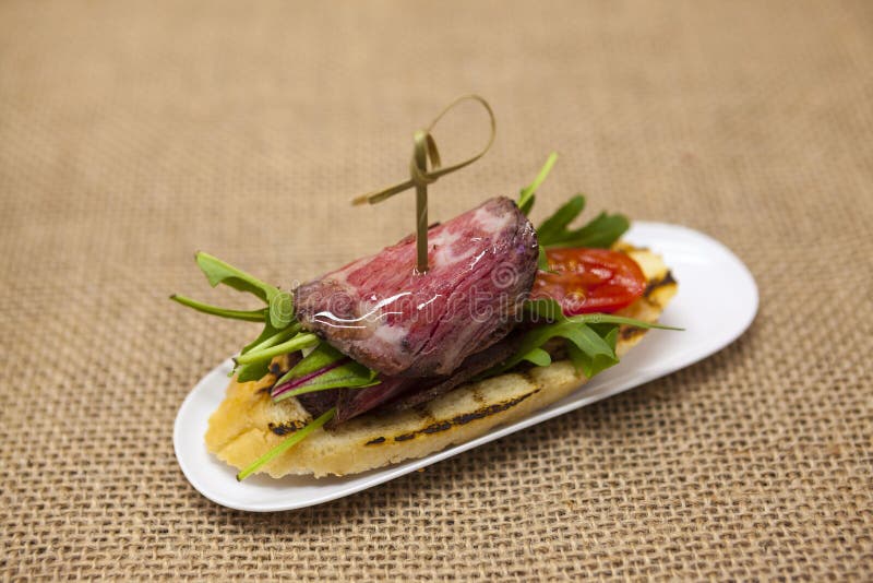 Fresh Delicious Spanish Tapas with Roast Beef on the Textiles