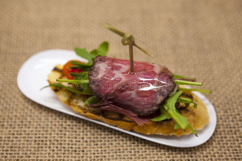 Fresh Delicious Spanish Tapas with Roast Beef on the Textiles