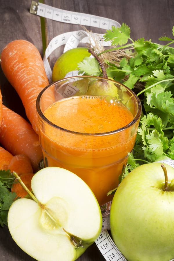 Fresh detox cocktail: carrot, apple and pear juice with herbs