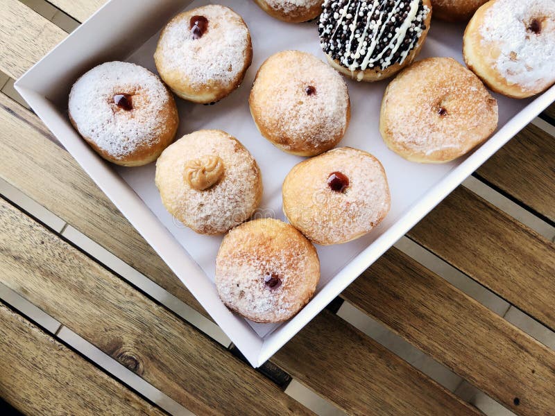 Fresh Donuts on Bakery Display for Hanukkah Celebration. Stock Photo