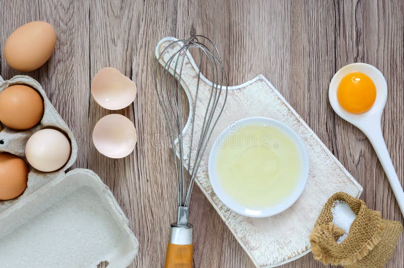 Fresh farm eggs on a wooden rustic background. Separated egg white and yolks, broken egg shells. stock photography Fresh farm eggs on a wooden rustic background. Separated egg white and yolks, broken egg shells. stock photography